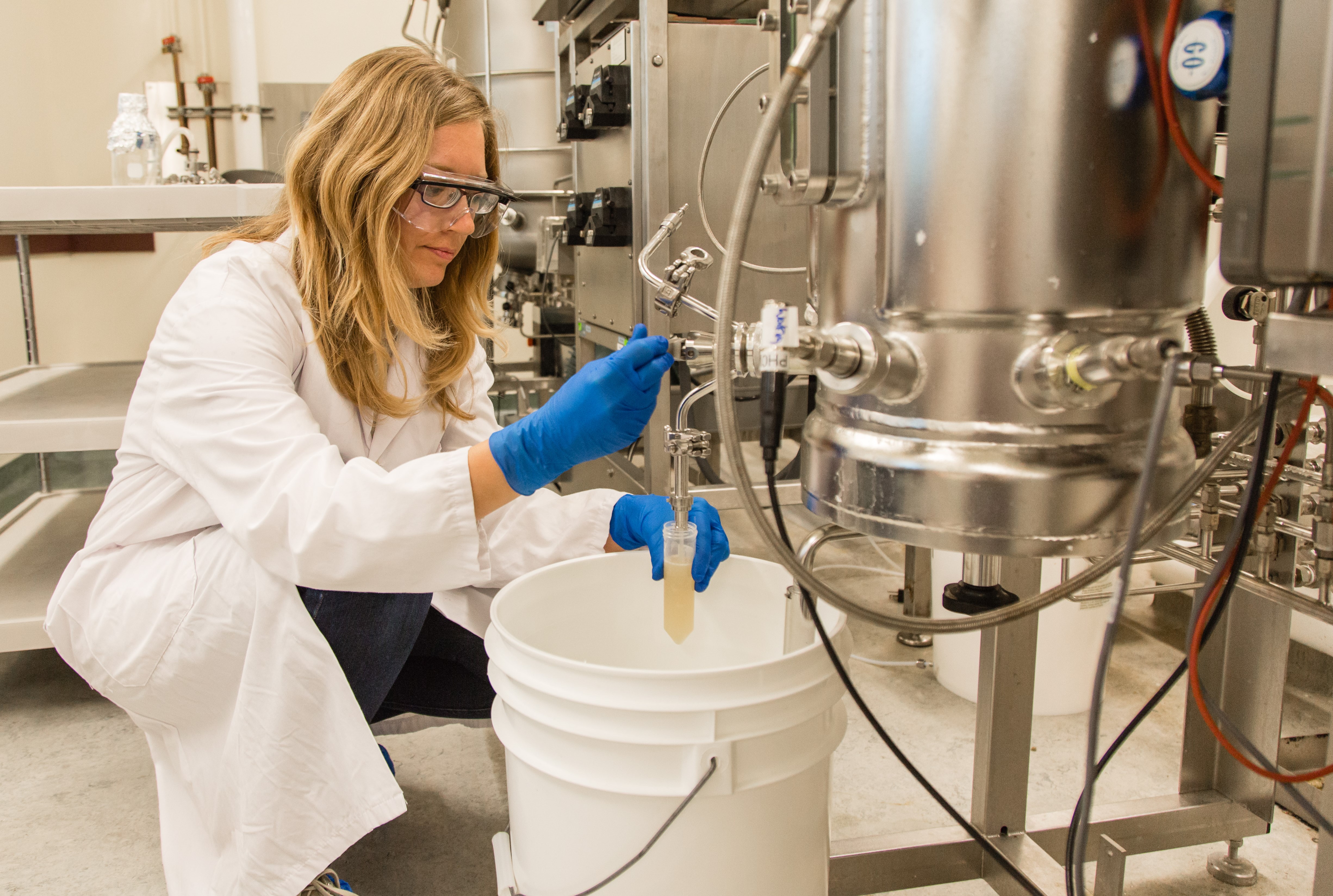 Doré taking a sterile contained sample from the bioreactor.