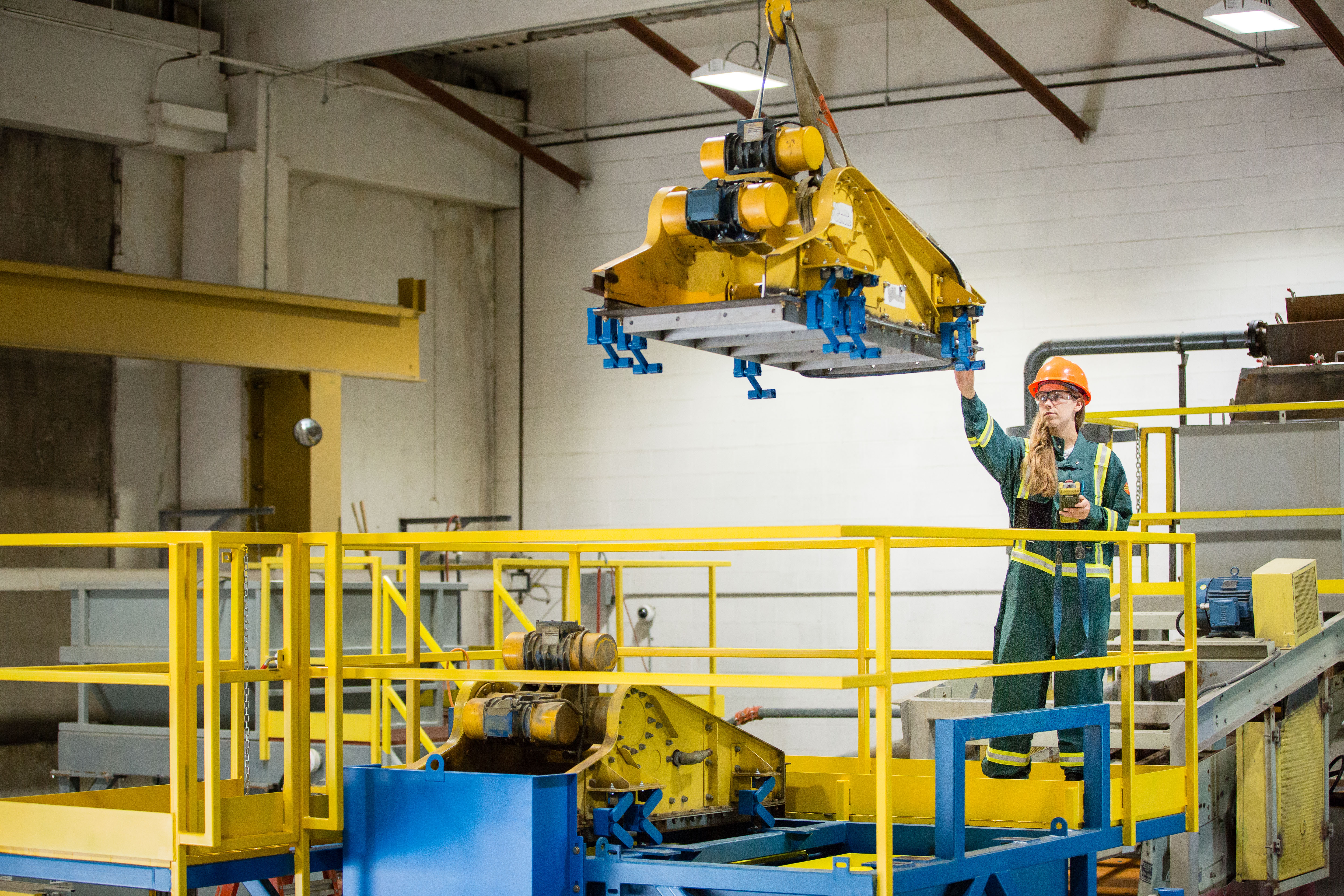 female engineer uses remote to move equipment
