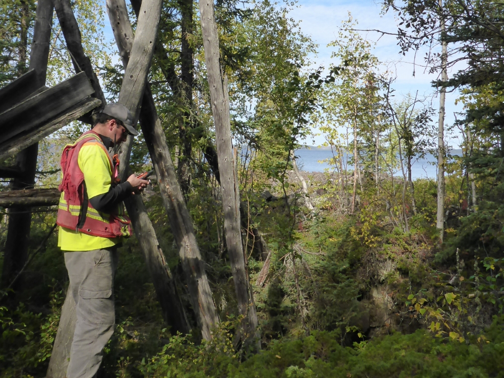 src remediation specialist looks at gps at an abandoned mine site