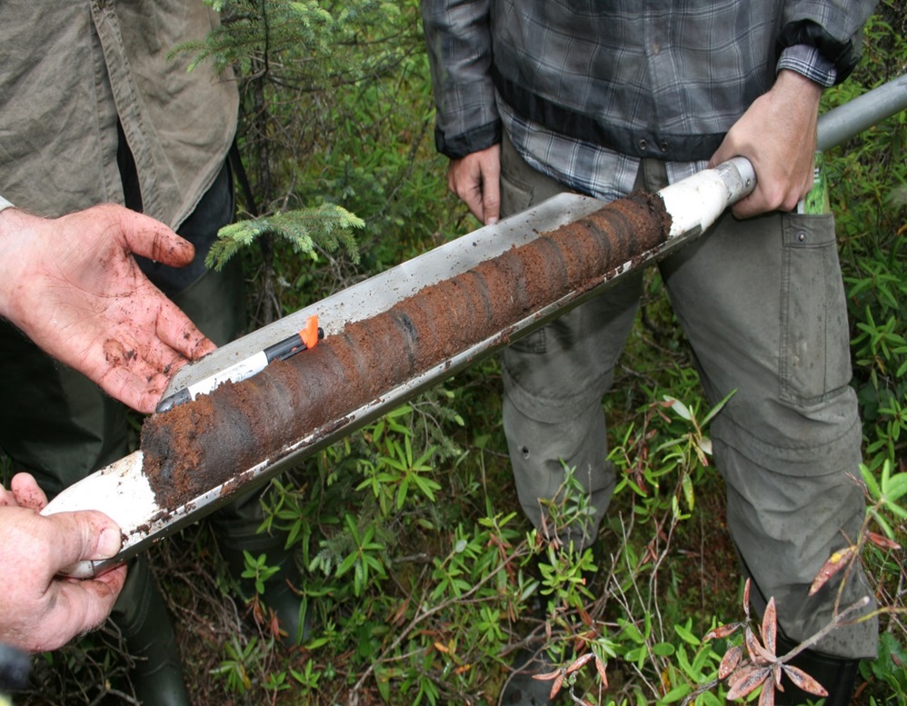 peat corer held by src research scientists