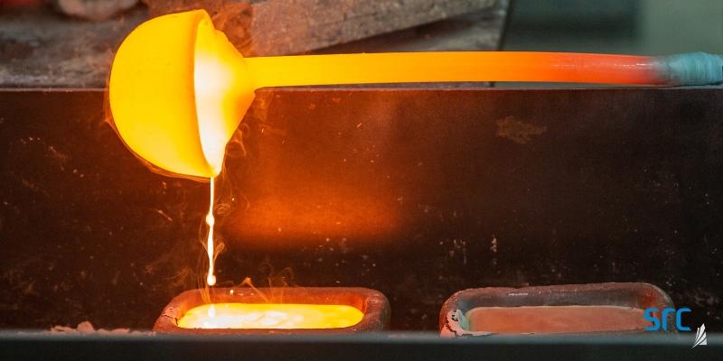 ladle pouring melted metal into a square case at src's rare earth processing facility