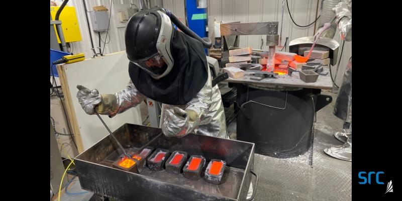 src employee pouring molten rare earths into casts to form ingots