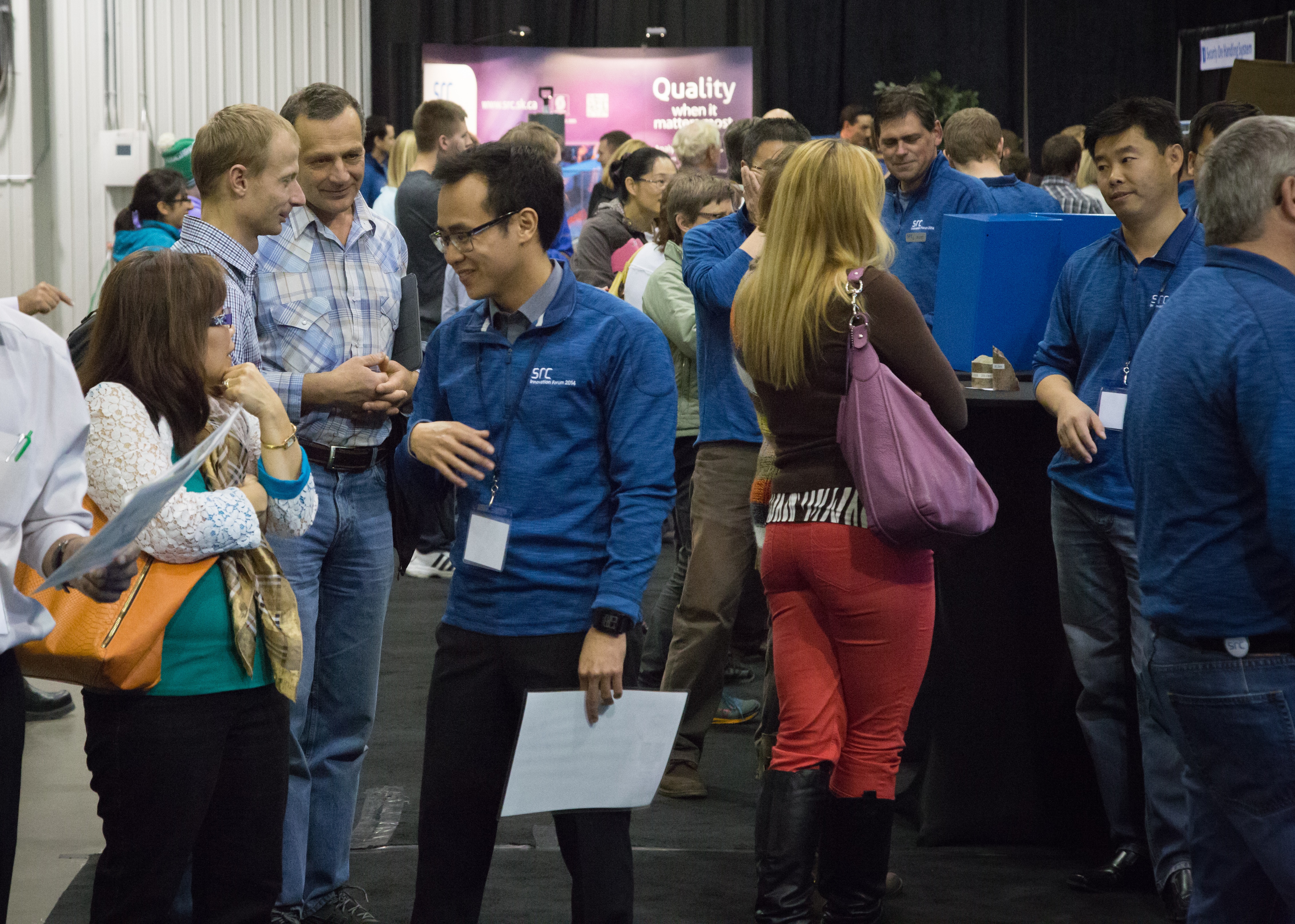 Employees talking with each other at an internal tradeshow