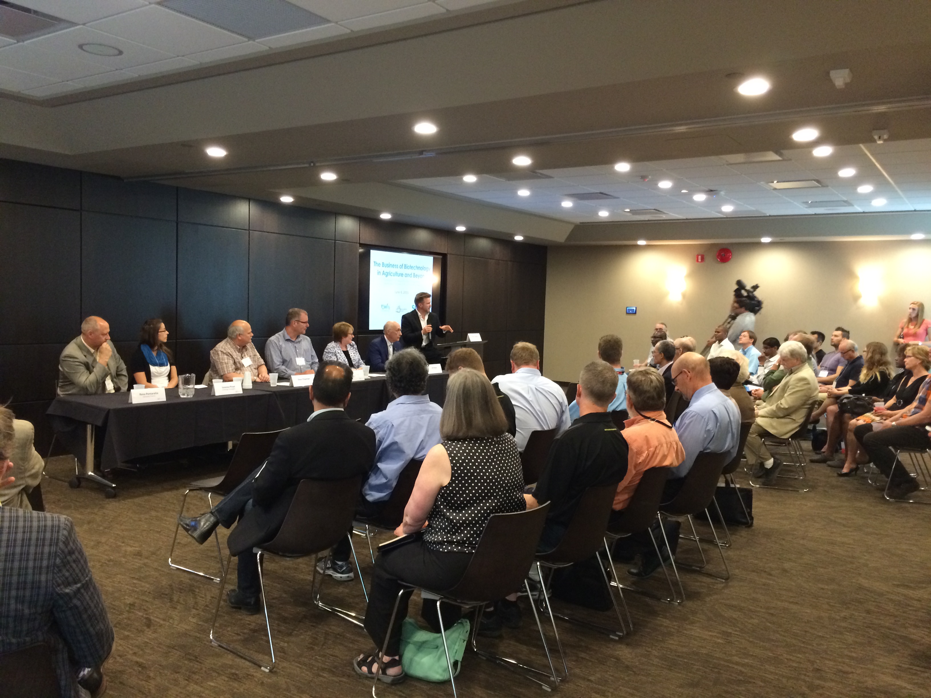 six panelists in front of a crowd