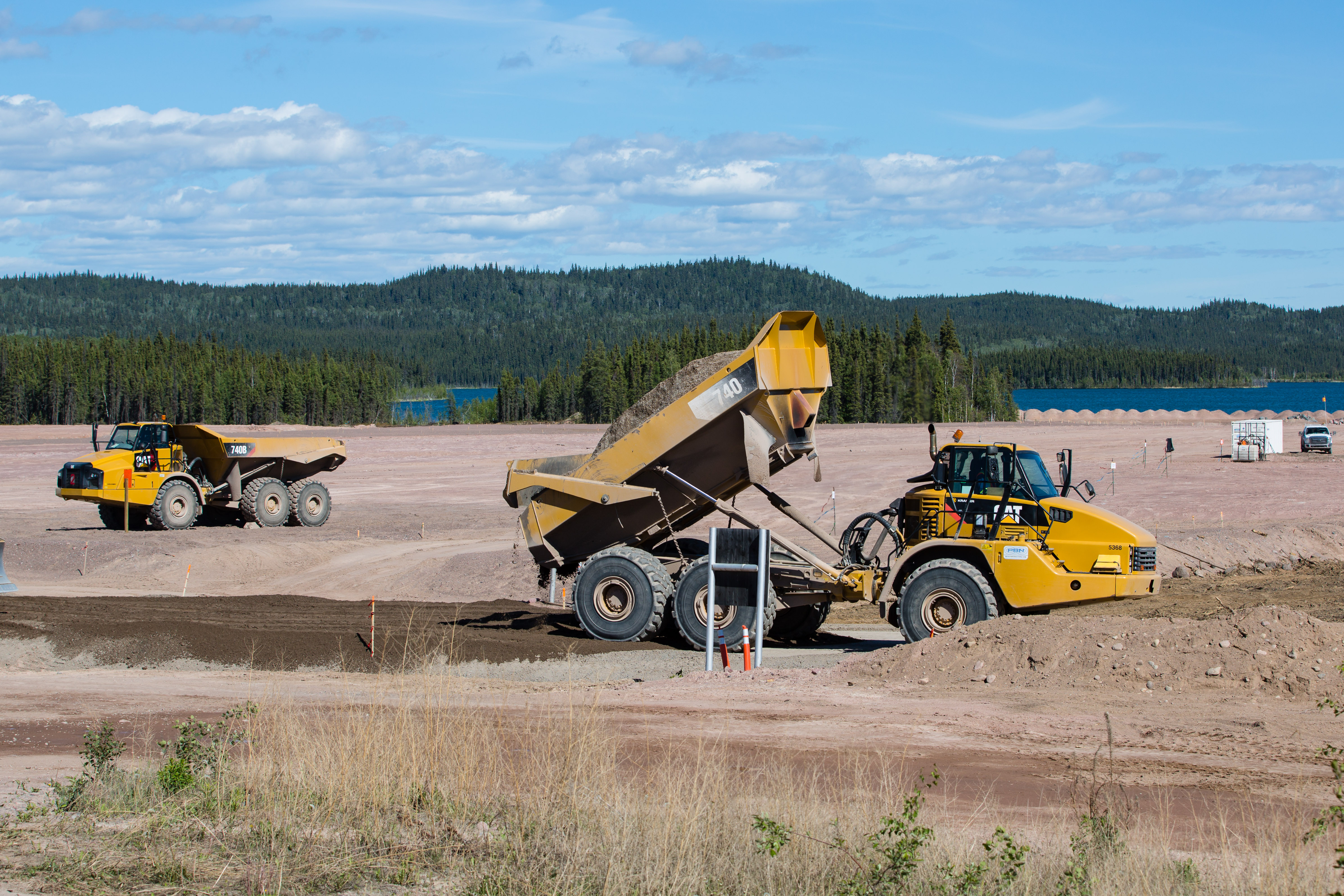 Large trucks haul material to cover Lorado site.