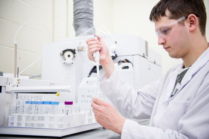 Lab technician puts sample into vial