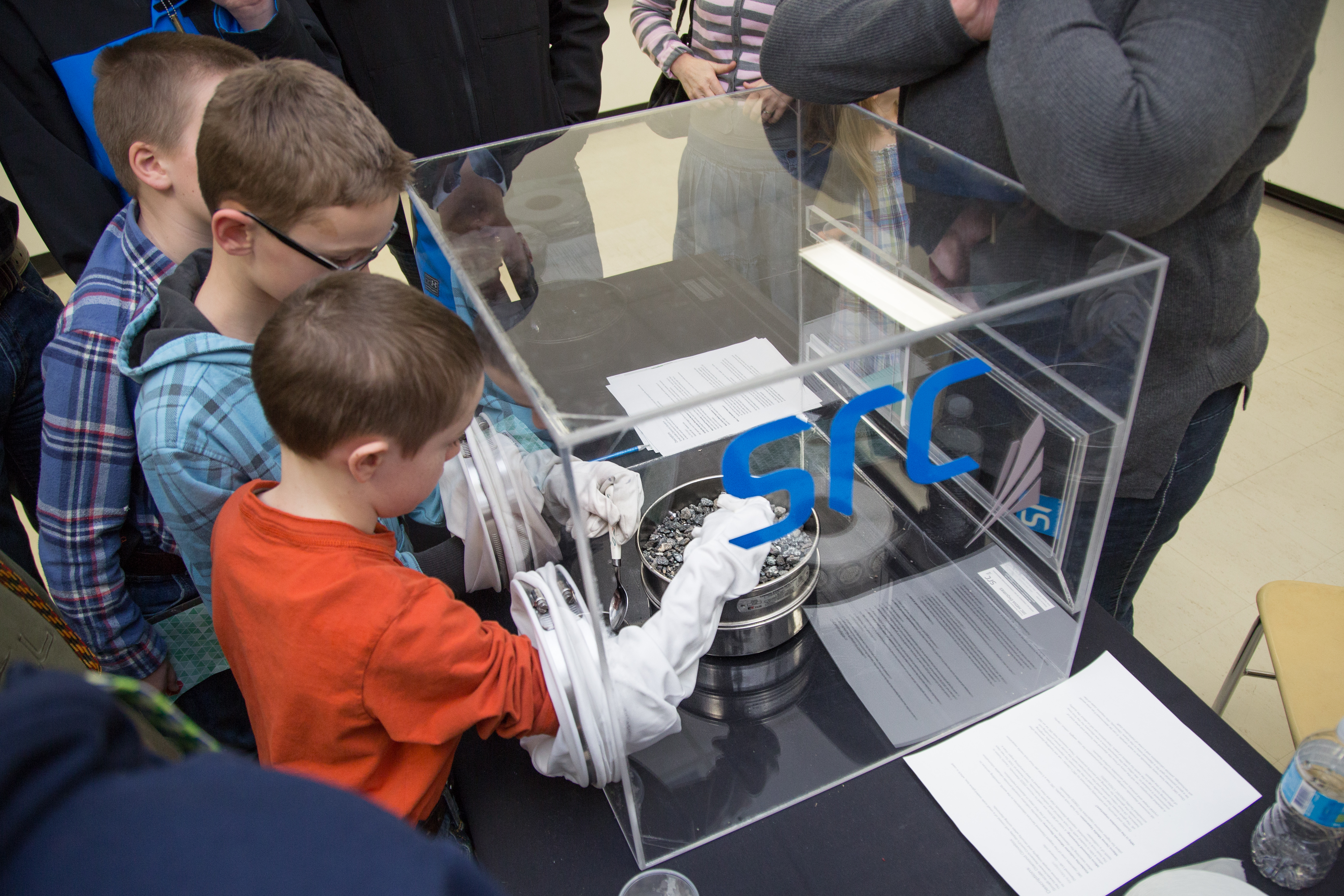 Students sort through rock samples using SRC's diamond glove box at Spectrum.