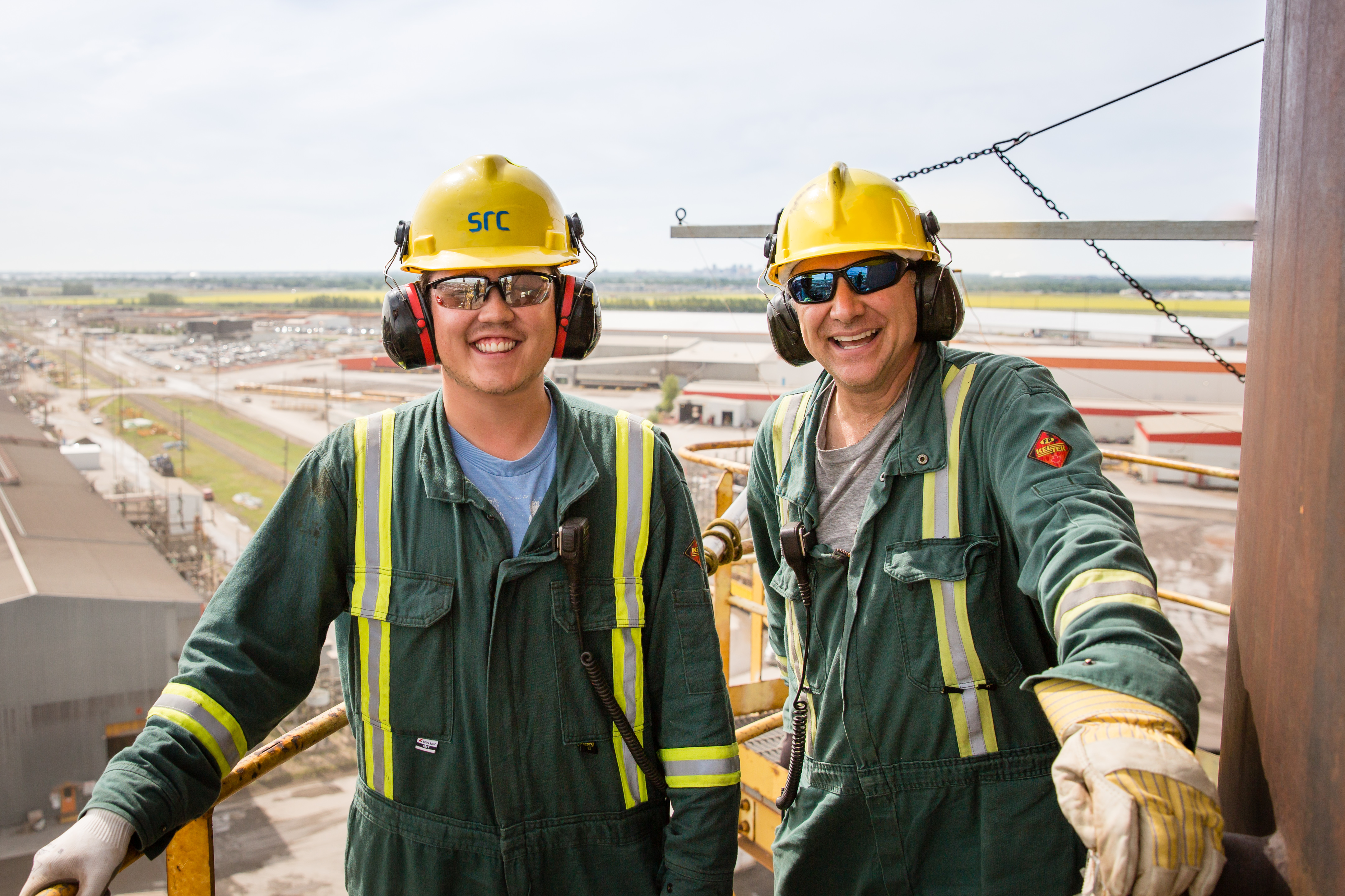 two field workers smile