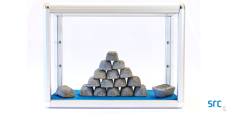 silver metal bars inside a glass case at src's rare earth processing facility