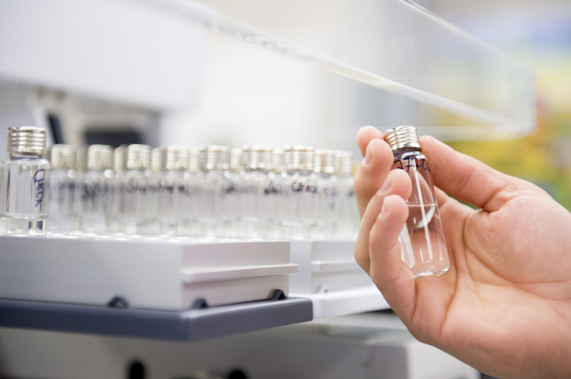 src lab technician holding a sample vial