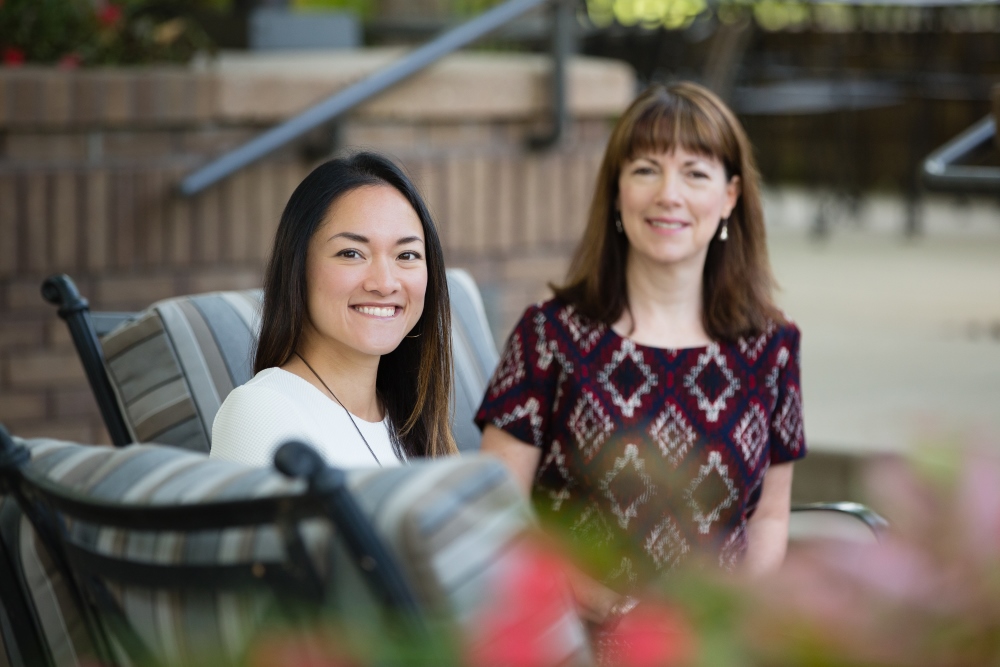 two female src employees sitting outside