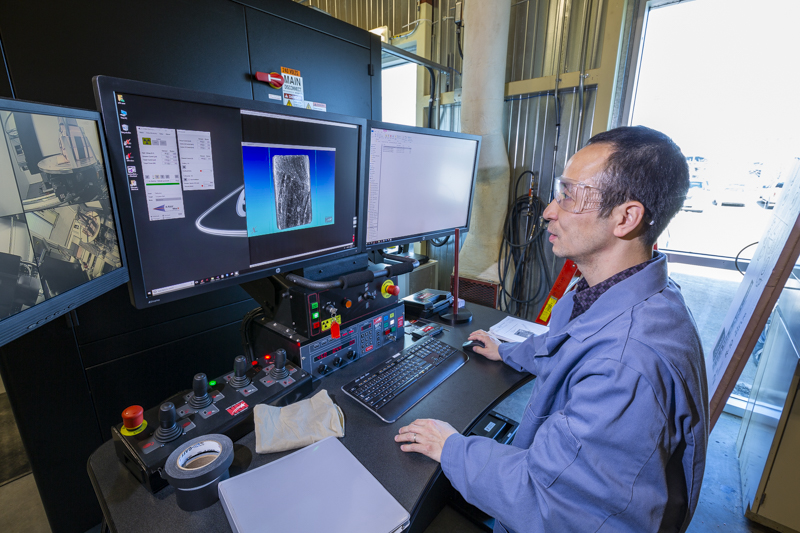 src research engineer works at computer on tight oil research