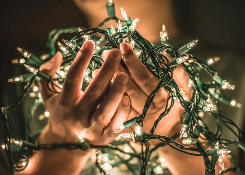 src holiday hours hands holding lights