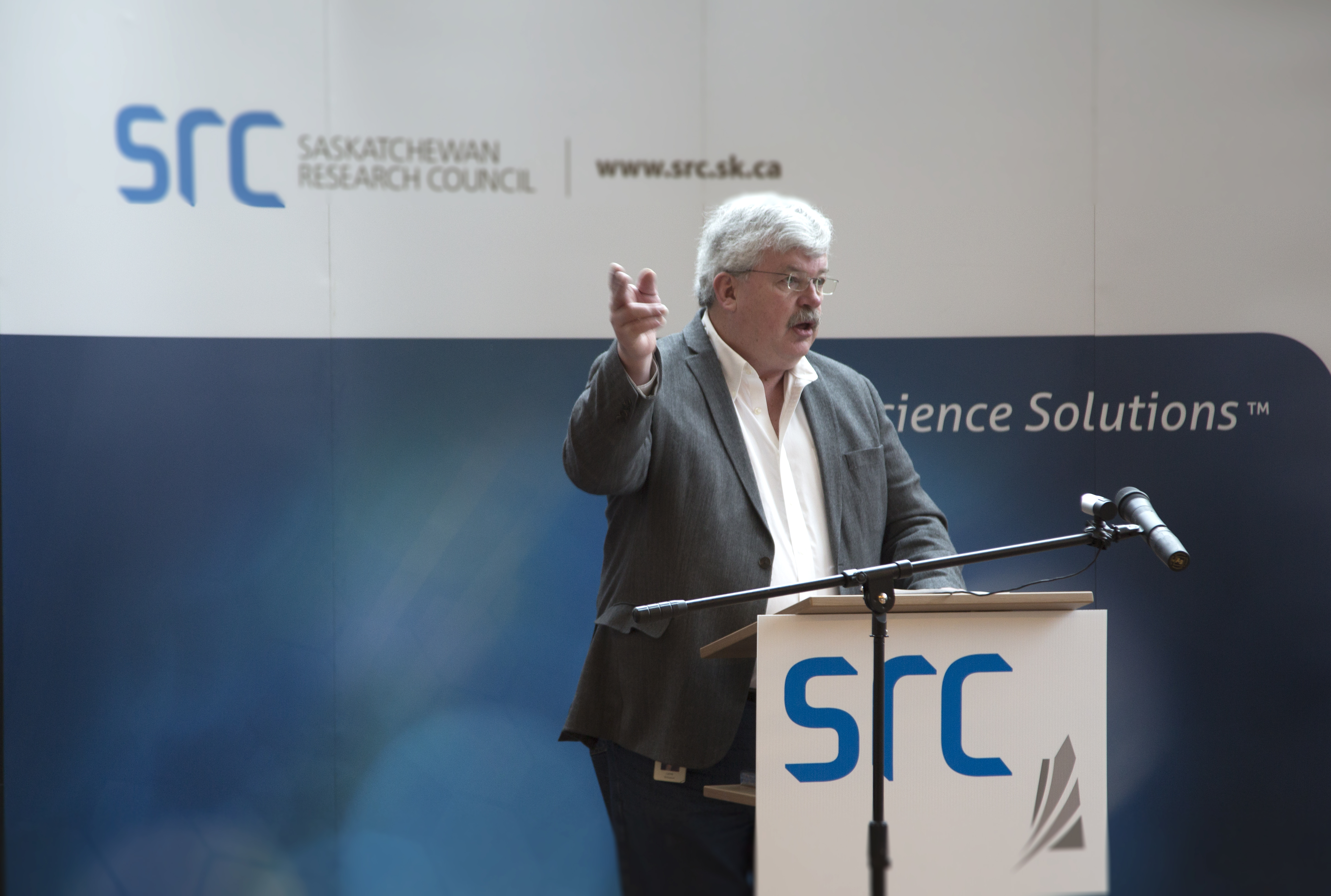 Laurier Schramm standing at podium