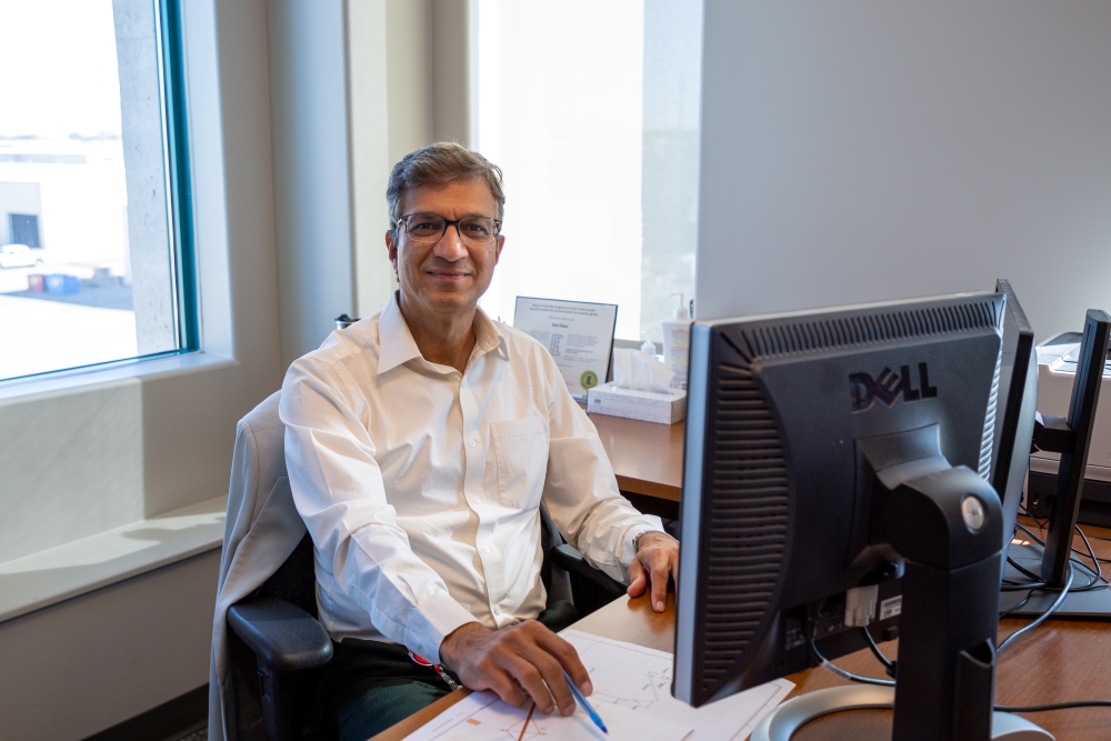 sunil sohani from src safety services sits at desk in office