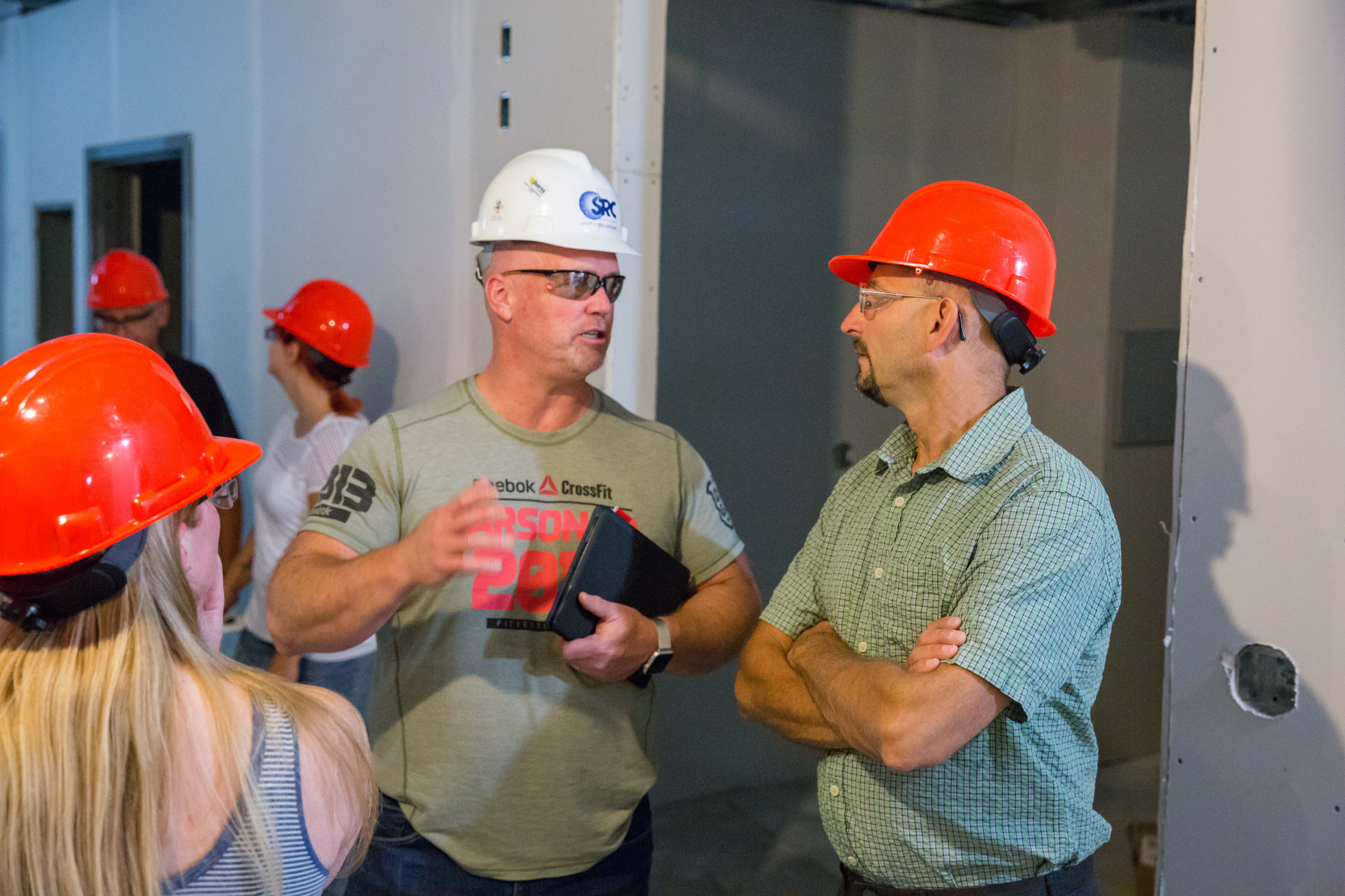 two men in hard hats talking