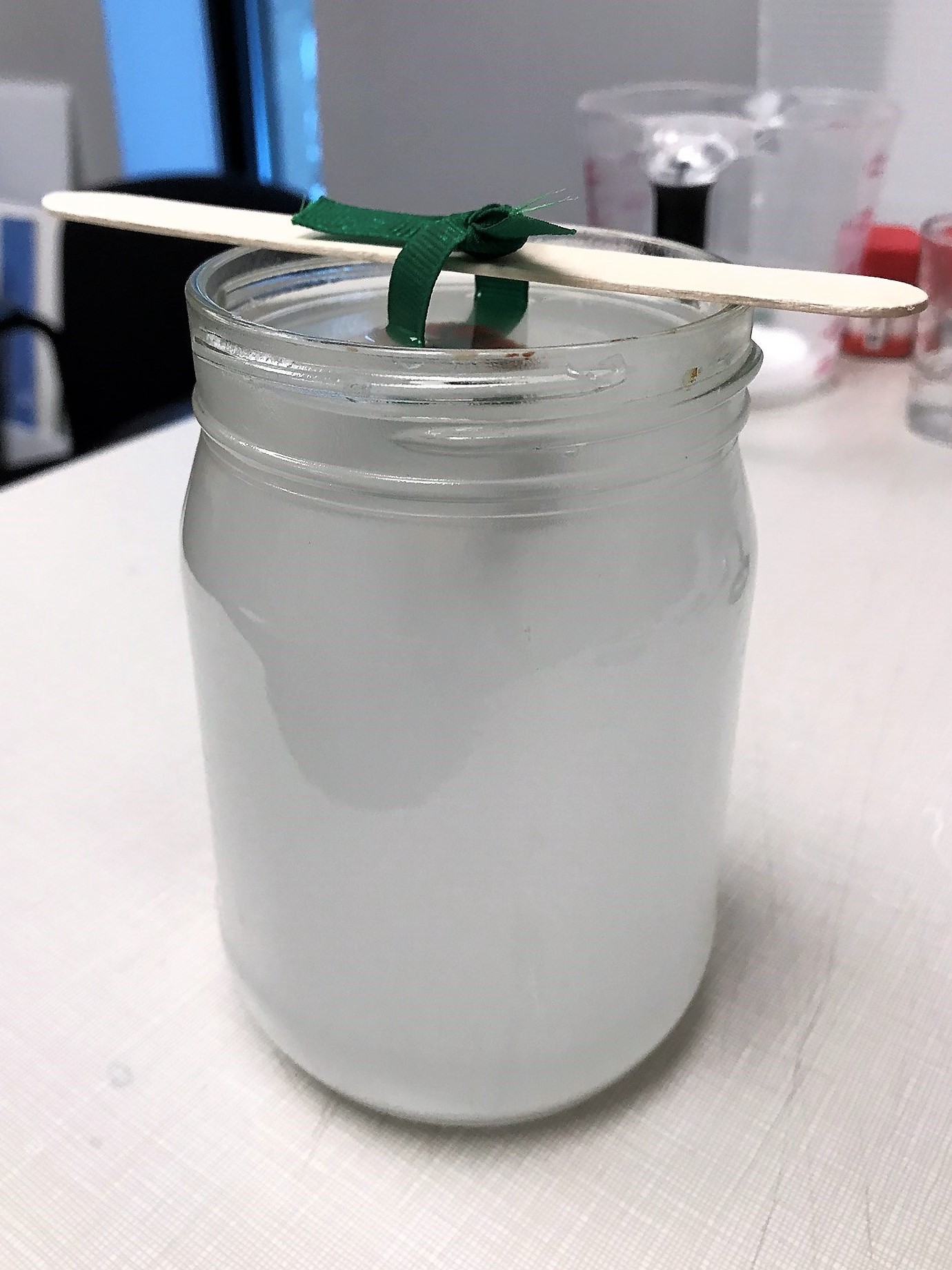 crystal candy cane dangling in glass jar