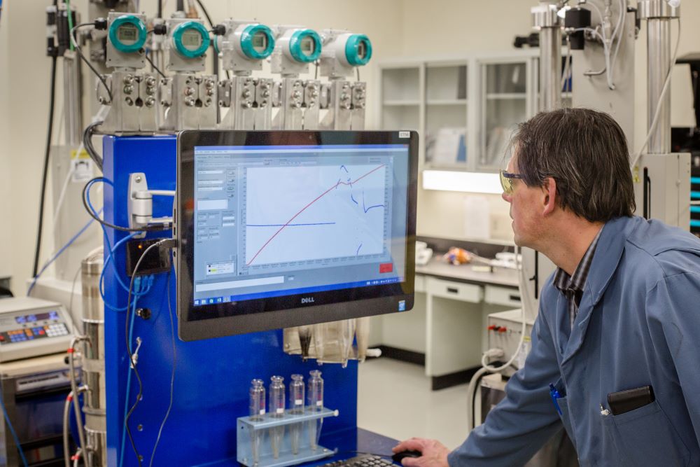 research engineer in src lab in front of computer screen