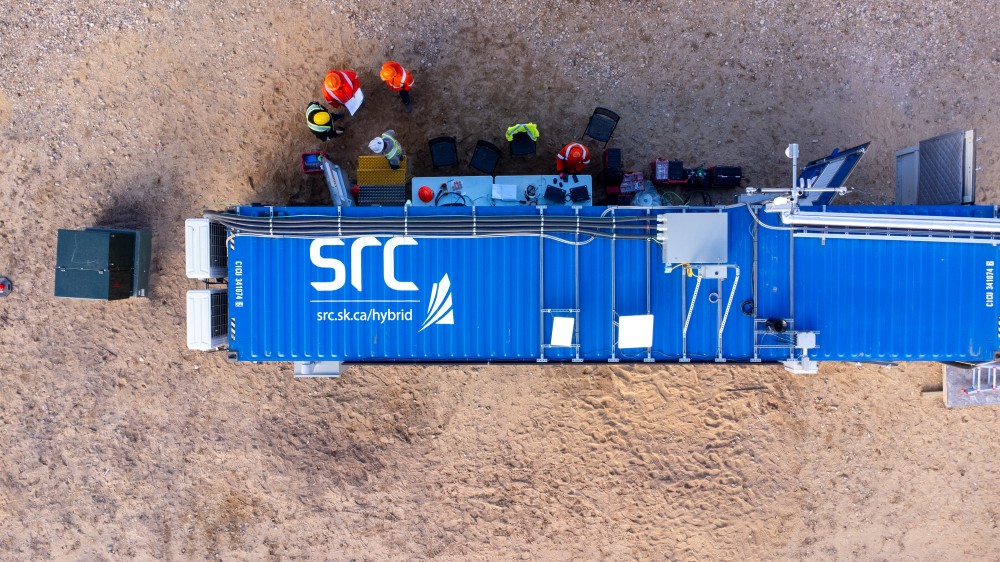 aerial photo of src's hybrid energy container with people standing outside it
