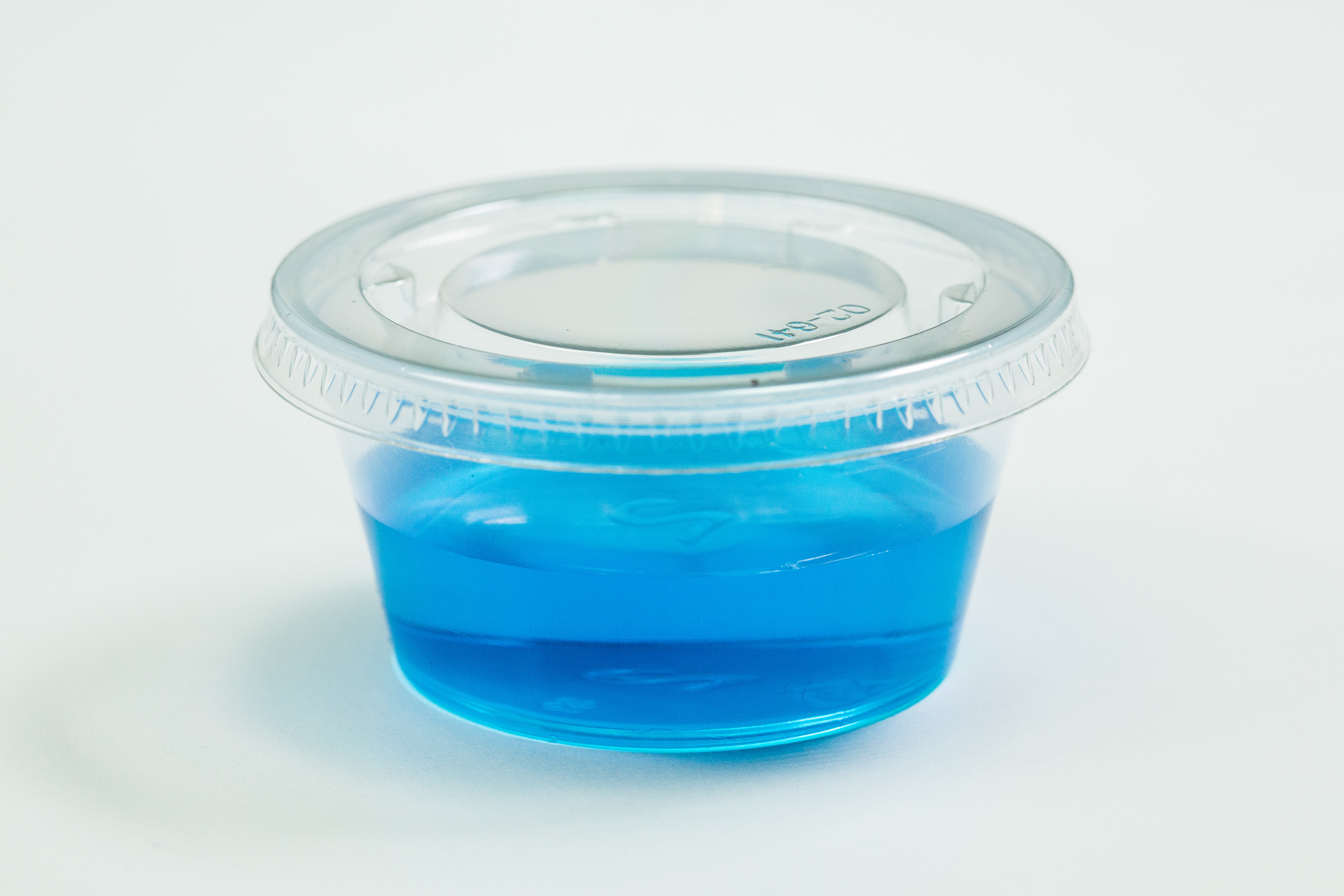 Clear plastic cup with blue liquid inside