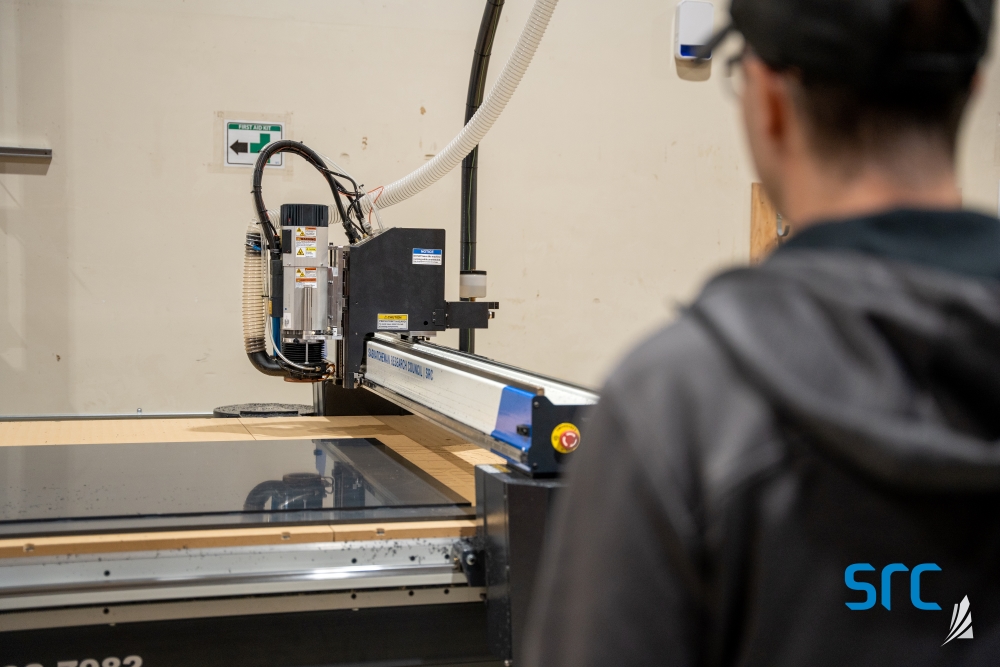 Man watches laser cutter at src