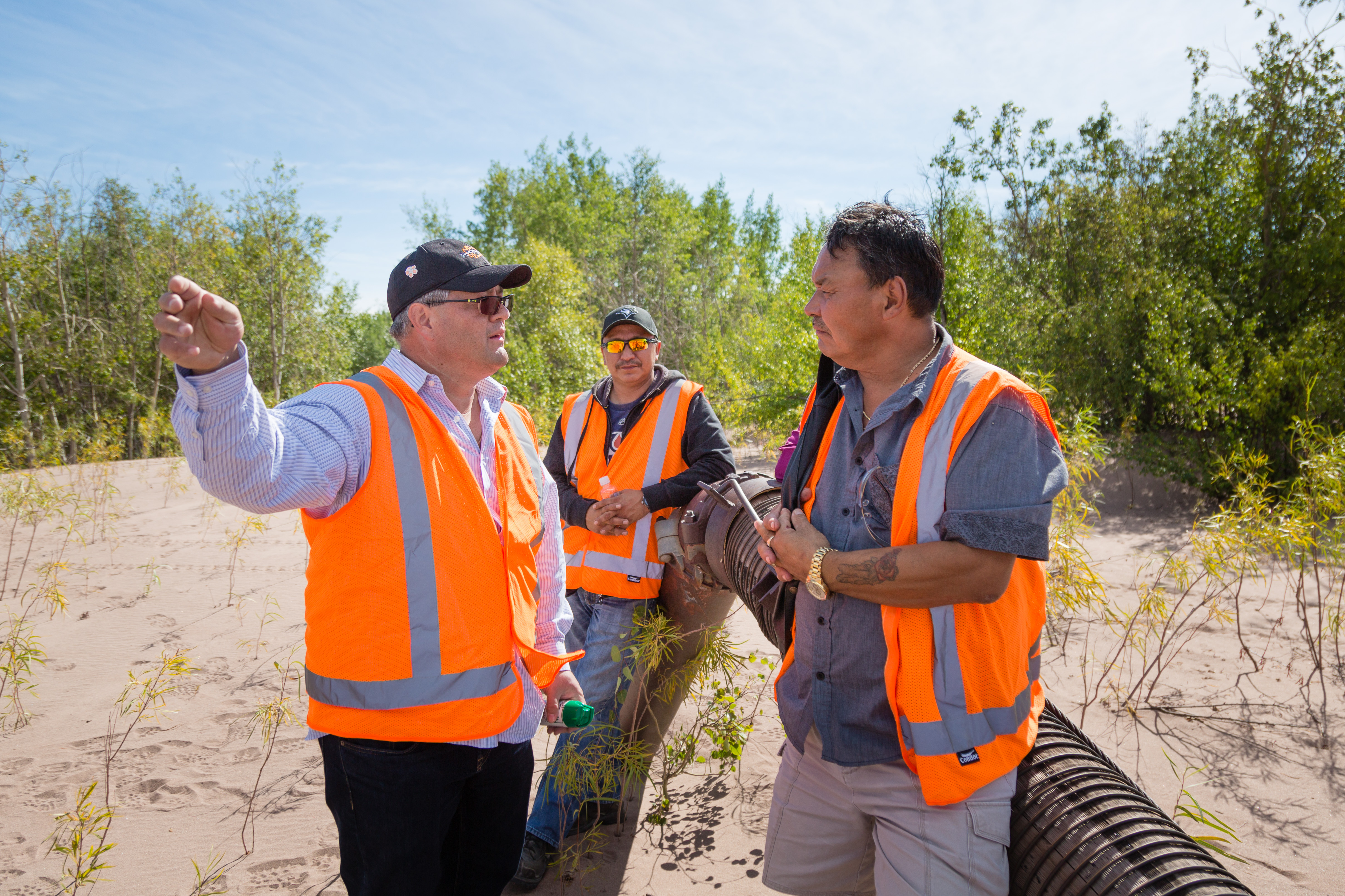 three men in safety vests at the gunnar mine site src