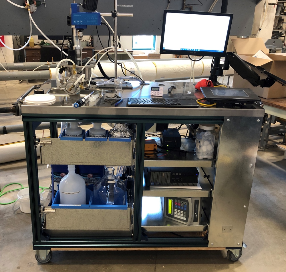 research engineer at src's pipe flow technology centre conducts oil sands test