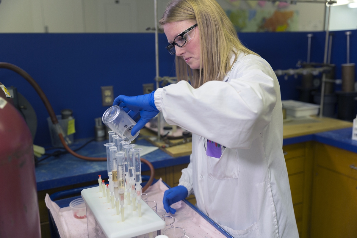 src laboratory technologist pours liquid into a tube