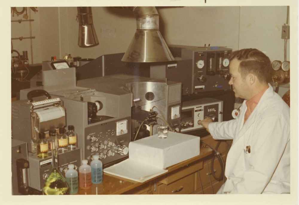 src environmental analytical lab employee at bench doing tests