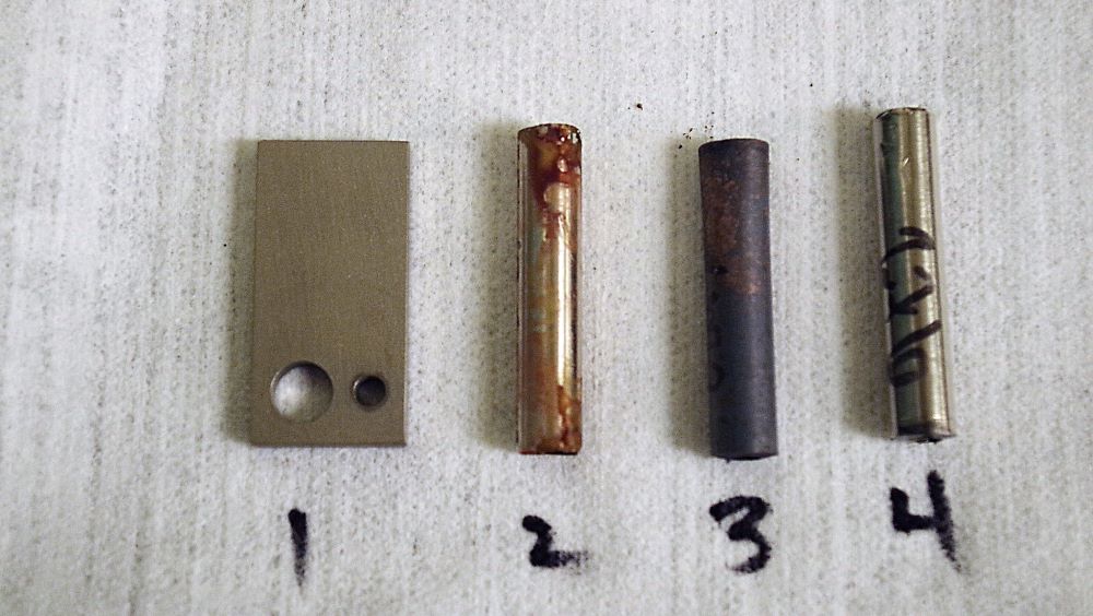 photograph of the four metal coupons in src lab test