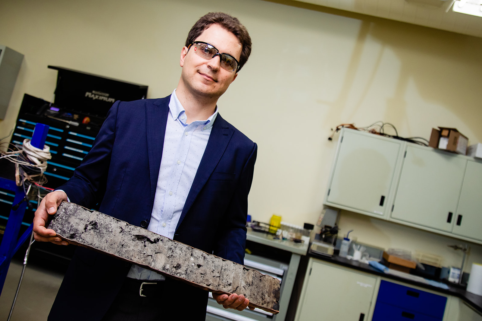 Petro Nakutnyy from SRC's Enhanced Oil Recovery Lab holding core sample