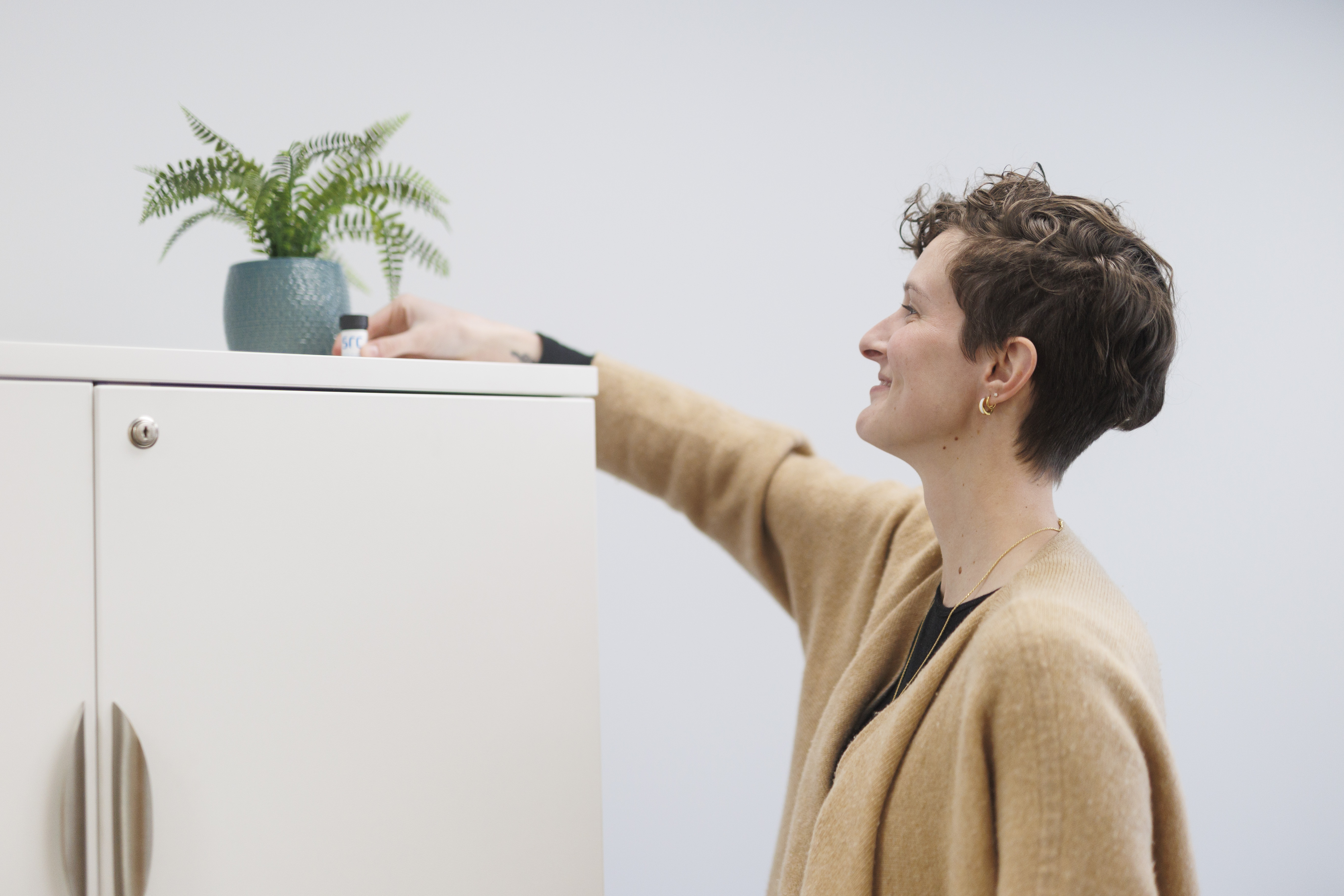 Bethany Verma from Lung Sask places a radon detector in their office (Photo: Lung Sask)