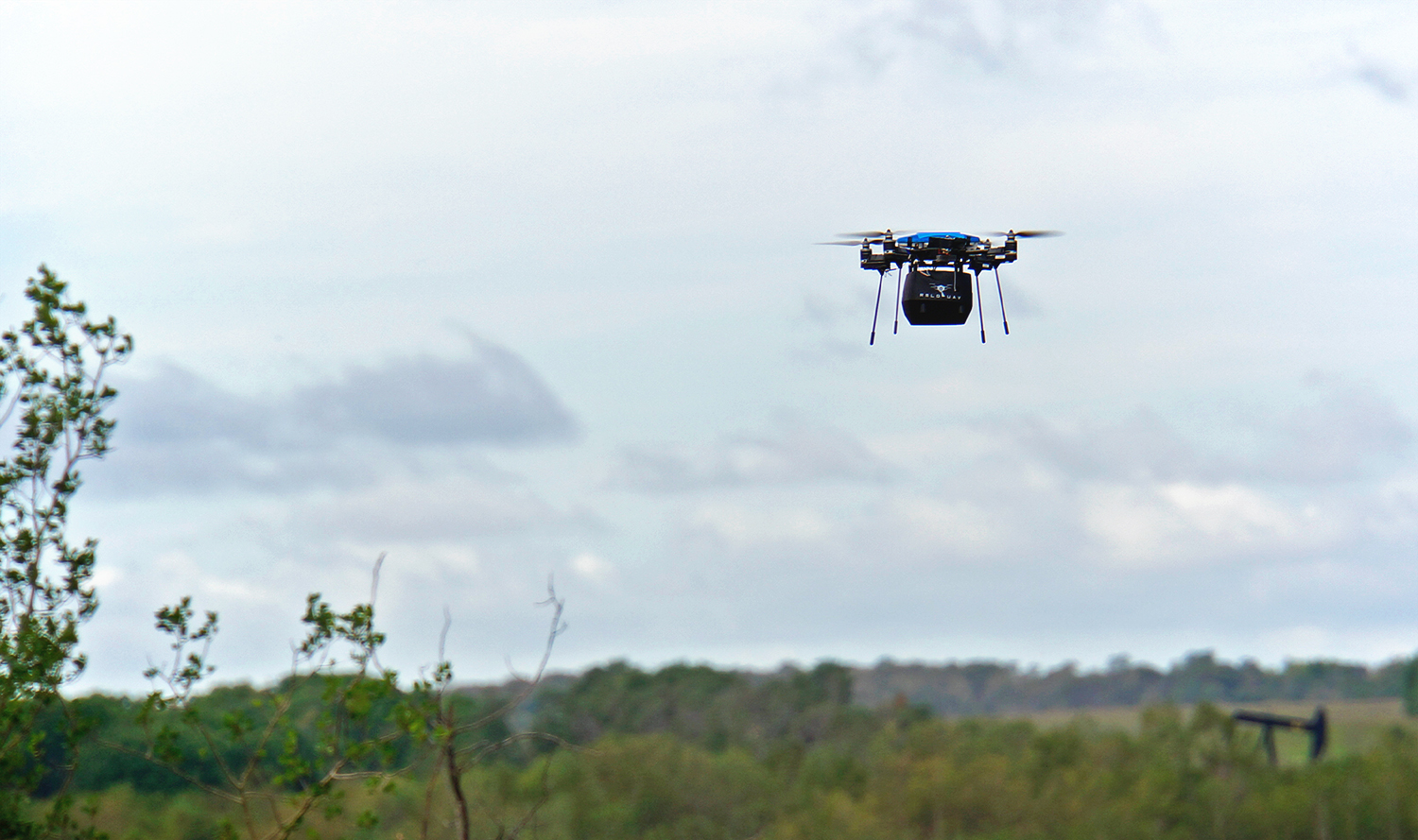 src unoccupied aerial vehicle flying in a forested area