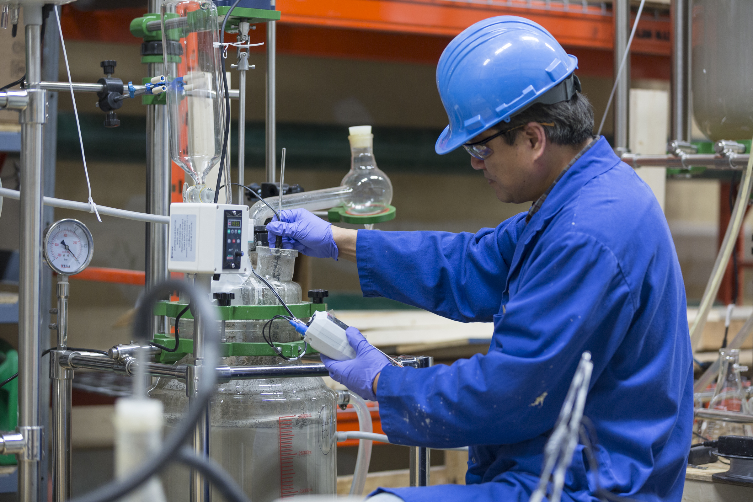 engineer in coveralls working in pilot plant