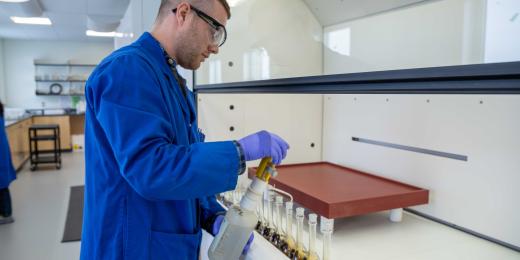 lab technician prepares uranium sample at src lab under fumehood