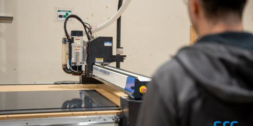 man supervises laser cutter at src