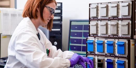src employee analyzing radioactivity level of a sample in a lab