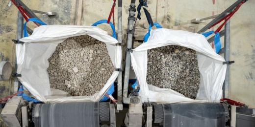 two bags of separate rock beneath two conveyor belts at src's sorting facility