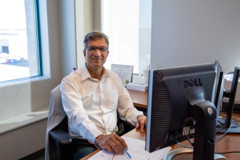 sunil sohani from src safety services sits at desk in office 