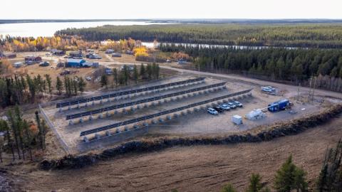 aerial photo of a northern lake community with a solar panel array and microgrid site