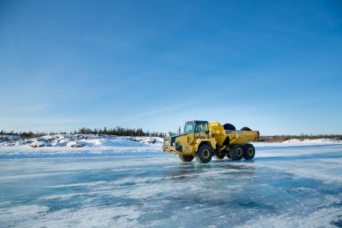 heavy equipment truck driving on ice
