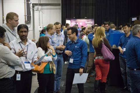 Employees talking with each other at an src internal tradeshow