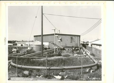 black and white photo of pipe loop and building