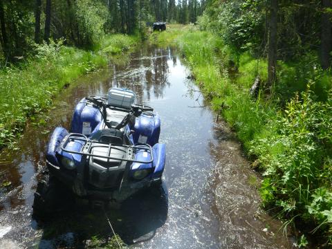 Quad stuck in mud in northern forest