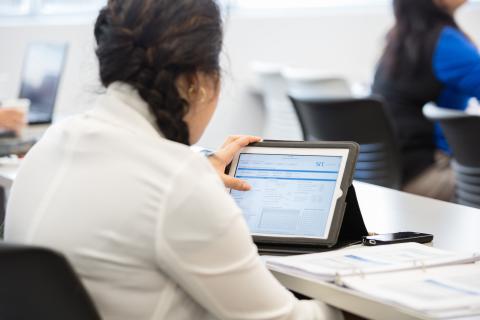 woman looking at src pipe flow model software on ipad