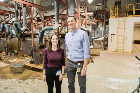 Saskatchewanderer and lab supervisor stand together in front of machinery