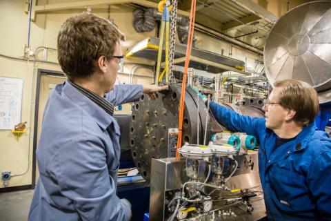 Two male src employees working in energy lab