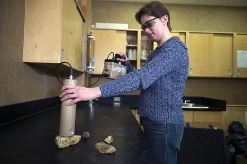 female scientist holding gamma ray unit