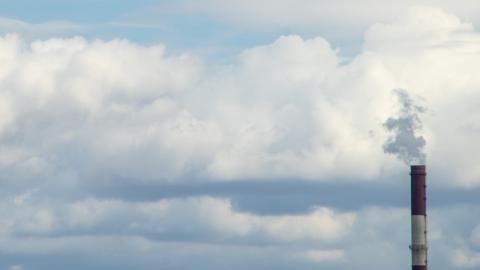 smoke from industrial stack against cloudy sky