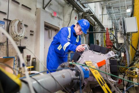 src employee running a pipe test in a lab